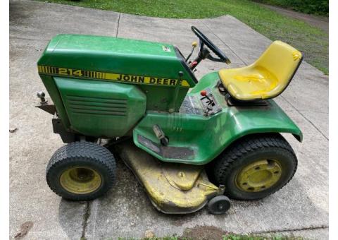 John Deere 214 riding lawnmower with mower deck, snow plow & Rototiller attachments